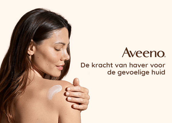 Aveeno. De kracht van haver voor de gevoelige huid. Vrouw brengt Aveeno-crème aan op de gevoelige huid.